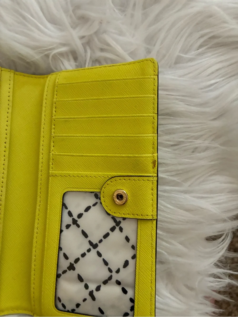 Lime green Kate Spade New York slim bifold wallet features multiple card slots